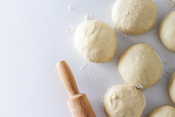 dough with rolling pin and flour on white table, bakery. dough kneading with rolling pin. baking bread, pizza