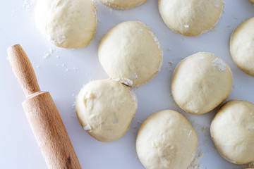 dough with rolling pin and flour on white table, bakery. dough kneading with rolling pin. baking...