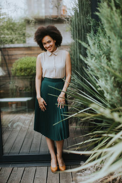 Pretty Young Curly Hair Woman  Standing In Backyard