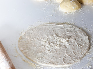 dough with rolling pin and flour on white table, bakery. dough kneading with rolling pin. baking bread or pizza