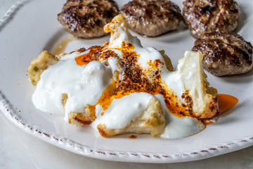 Healthy Organic Vegetarian Cauliflower with Yogurt, Fried Butter Sauce and Turkish Style Meatballs Kofte or Kofta / Yoghurt.