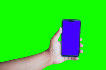 Man holding phone with chroma key display against the green screen background