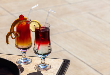 Two cocktails by the pool. Selective focus, place for text