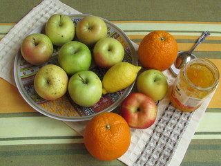 Apples delicious orange oranges yellow lemon are on the plate. Still life was made and photographed by a girl Nastya 7 years old.
