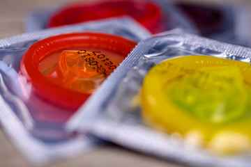 Close up shot of various colored condoms