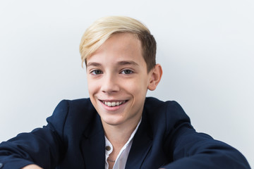 Close-up of teen boy with braces on teeth smiling on white background. Dentistry and teenager...