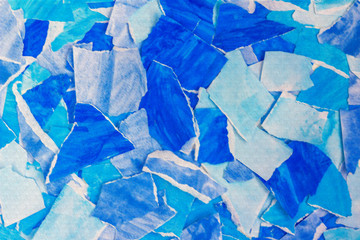 Blue abstract background from torn pieces of paper. Paper collage. Template for graphic design, wallpaper, covers and wrapping paper. Copy space for text