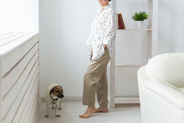 Woman wearing cozy home shirt relaxing at home and playing with dog jack Russell terrier. Morning concept.