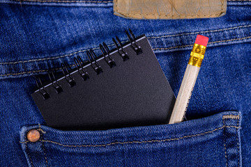 Jeans back pocket with notepad and pencil