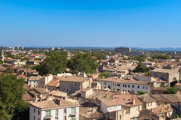 Fototapeta na wymiar Beautiful summer photo of the roofs of houses taken from a city park in Avignon, France (commune in South-Eastern France in the department of Vaucluse on the left bank of the Rhône river)