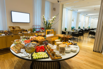 Breakfast served on round buffet table in hotel restaurant