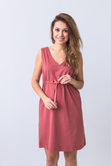 Fashion, summer and vacation concept - beautiful female model in brown dress on white background.