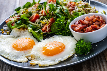 Continental breakfast - sunny side up eggs, bacon and vegetable salad