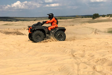 A man riding a quad bike in the desert