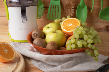 Fresh fruits on a wooden background, cutting wooden board and knife
