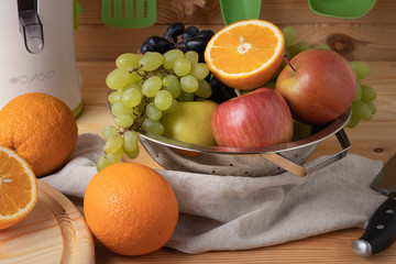 Fresh fruits on a wooden background, cutting wooden board and knife