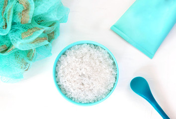 Spa background with natural cosmetics, sea salt, sponge and cosmetics. Top view on white background