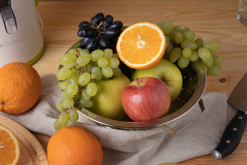 Fresh fruits on a wooden background, cutting wooden board and knife
