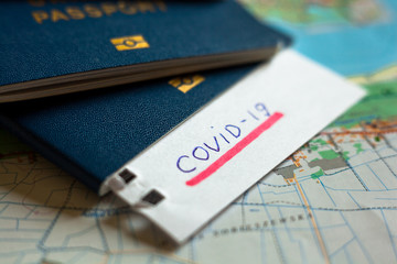 Passport and note with Covid-19 inscription.