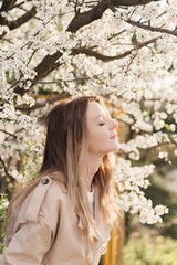 Closeness to nature. happy beautiful girl in blooming gardens. Natural beauty