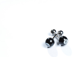 A pair of stainless steel cufflinks on white background.