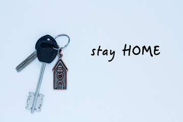 bundle of keys with a keychai in in the form of a house. Inscription stay home