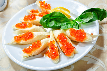 Traditional Russian pancakes with red caviar.