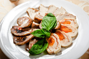 Turkey roulade slices stuffed with prune and walnuts.