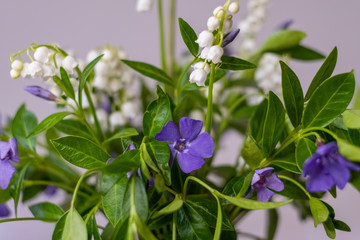 bouquet of spring flowers with lilies of the valley and periwinkle Selective focus