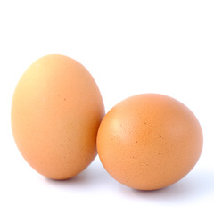 Close-up top view of organic raw eggs on white background with copy space for your text, healthy eating concept.