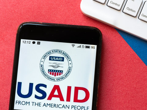 In this photo illustration USAID logo is seen displayed on a smartphone