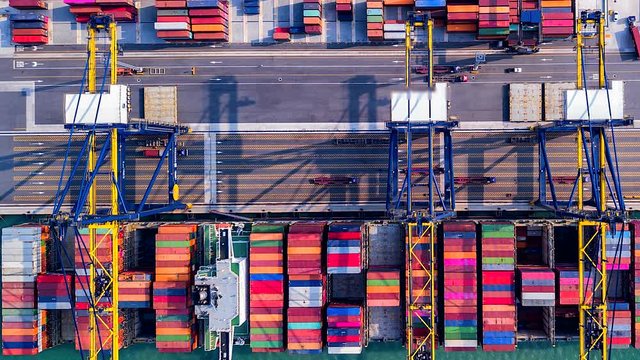 4K Timelapse of modern industrial port with containers from top view or aerial view. It is an import and export cargo port where is a part of shipping dock.Singapore