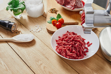 Chopped raw meat and ground beef . The process of preparing forcemeat by meat grinder. Top view.