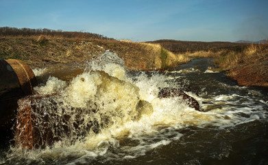 Discharge of waste water into the river. Violation of environmental ecology.