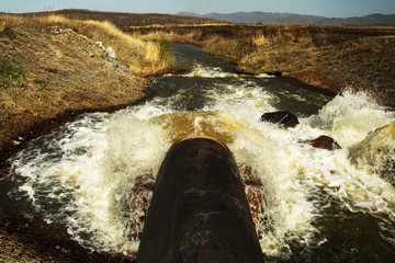 Discharge of waste water into the river. Violation of environmental ecology.