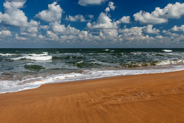 View of the sunny sandy beach and cloudy blue sky