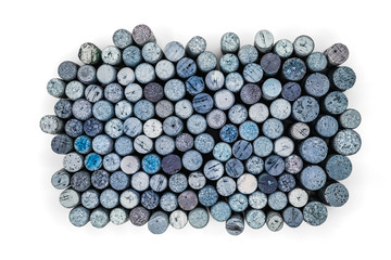 Old blue Used corks plugs from various types of wine on white background