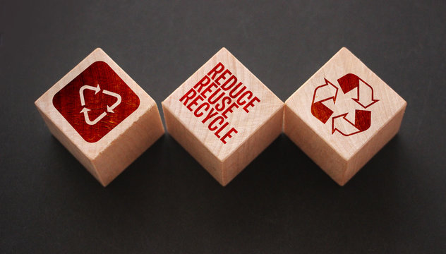 Reduce, reuse and recycle word written on wooden blocks on black. Save the planet Ecological concept