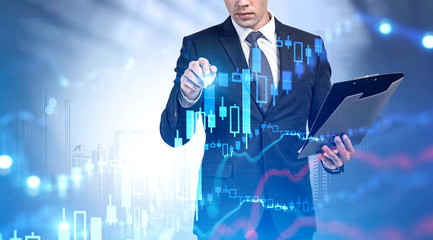 Man with clipboard working with digital graph