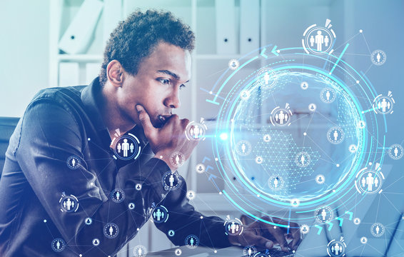 Serious African man with laptop, social network