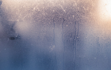 Foggy window, blue tinted background texture