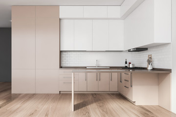Fototapeta na wymiar White and beige kitchen interior with island