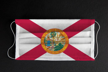 Coronavirus Covid-19 in Florida state. Flag of the State of Florida printed on medical mask on...