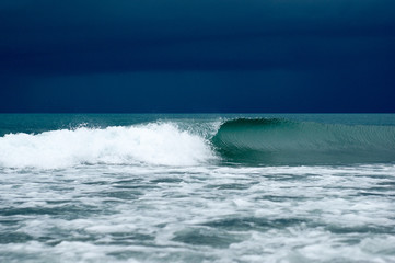 sea wave rolls ashore in a storm