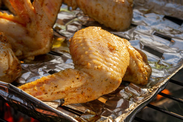 Macro roasted chicken wings. Summer picnic concept. Chicken wings on barbecue grill.