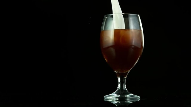 Super slow motion of pouring ice coffee into glass. Filmed on high speed cinema camera, 1000fps.