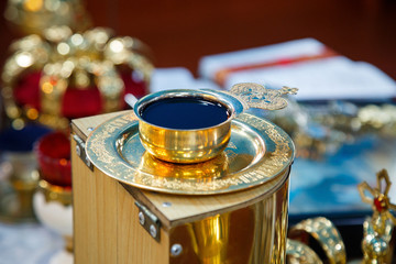 Church wine in a golden bowl. Religious traditions