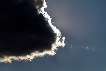Cloudscape. Blue sky and grey cloud. Sunny day. Cumulus cloud.