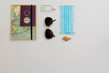 Flat lay travel post COVID19 outbreak concept with traveller objects and accessories styled in a neat and organised fashion, on a bright white background