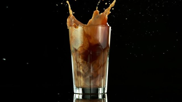 Super slow motion of falling ice cube into ice coffee drink. Filmed on high speed cinema camera, 1000fps.